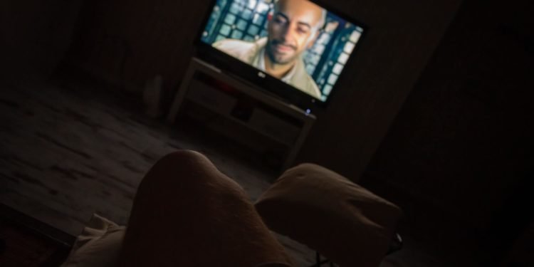 A person watching Tv