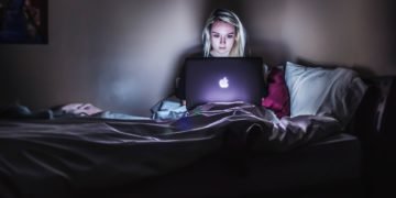 A woman watching shows on her laptop